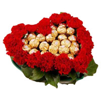 Gifts to India. 24 Red Carnation 24 Ferrero Rocher Heart Arrangement