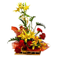 Send Flowers for Diwali contains 6 Yellow Lily 6 Red Carnation Arrangement of Flower to India