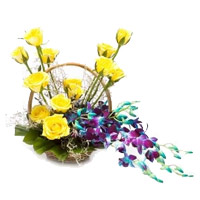 Send 6 Orchids and 12 Roses Arrangement of Rakhi Flowers to India